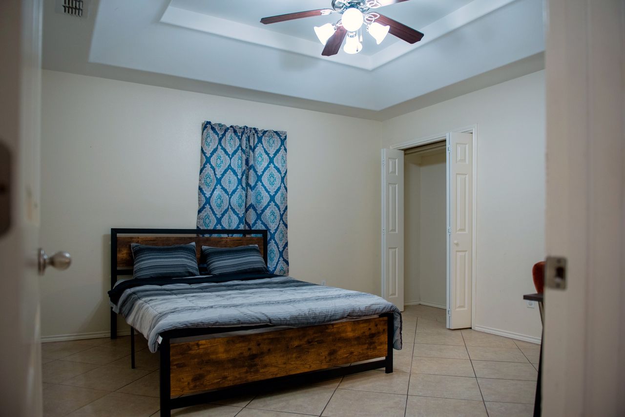First bedroom with a large bed and double closet